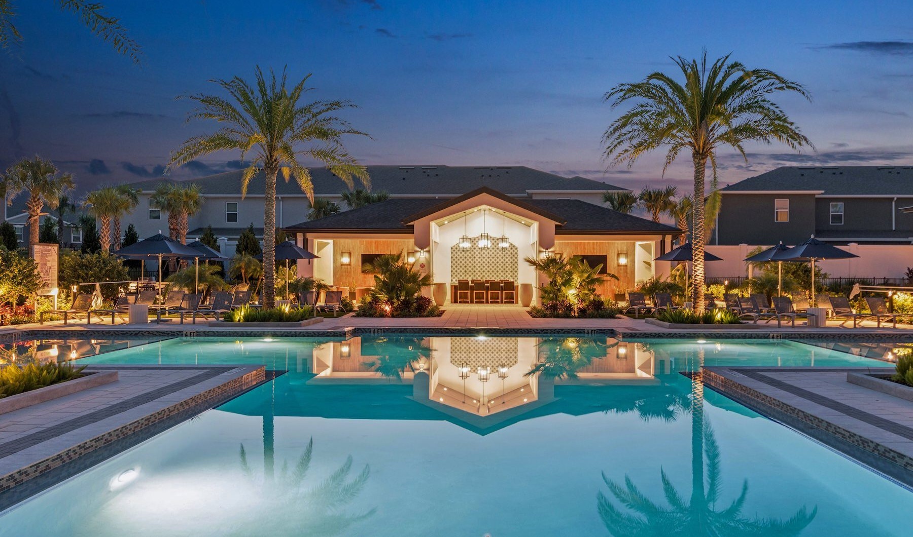 pool with lounge chairs at dusk